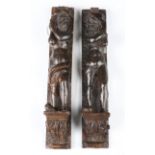 A near pair of 18th century Continental carved fruitwood figural pilasters, each modelled with a