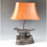 A 20th century cold cast bronze table lamp, modelled in the form of a setter dog standing on an oval