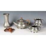 A Liberty & Co Tudric pewter three-piece tea set, the teapot with wicker bound handle and all-over