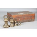 A part set of five George V bronze bell weights by De Grave & Co Ltd, ranging from 28lb to 1lb, each