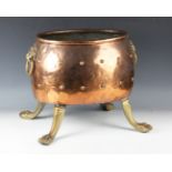 An early 20th century Continental copper and brass studded oval log bin with lion mask ring