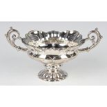 A Continental silver two-handled bonbon bowl of faceted form, in a floral medallion design with