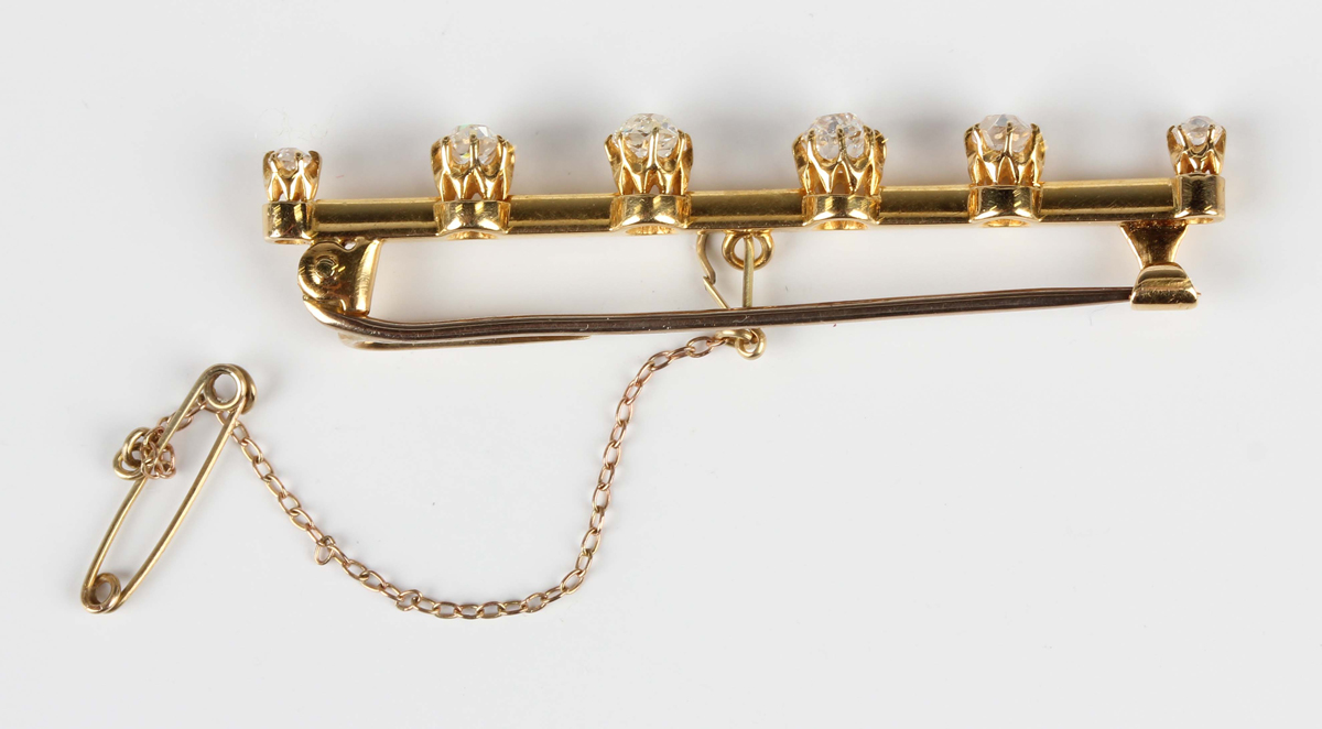 An Edwardian gold and diamond six stone bar brooch, claw set with a row of cushion cut diamonds - Image 4 of 4