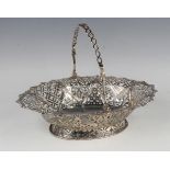 A George III silver oval basket with pierced swing handle above pierced and beaded lattice panels