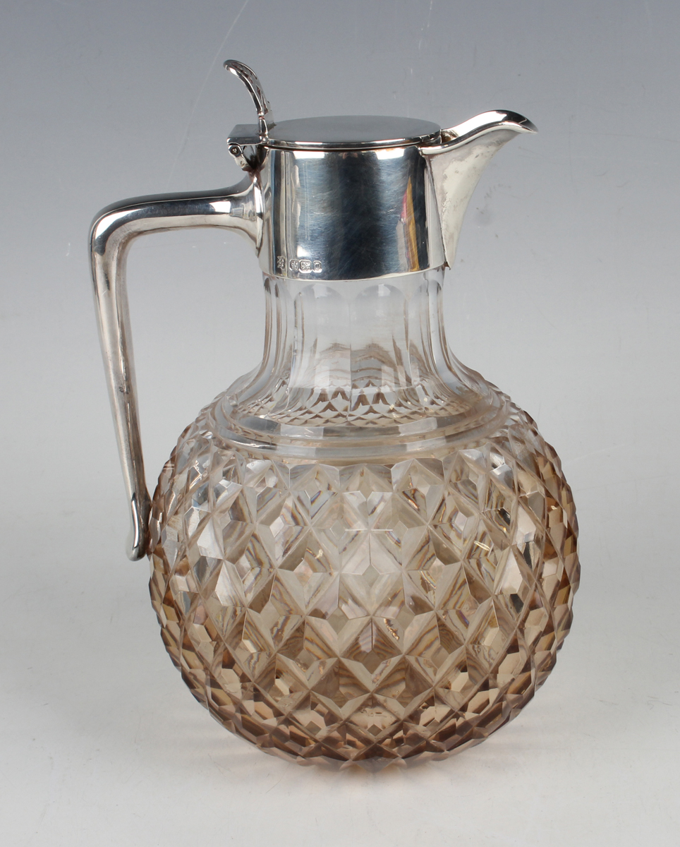 A late Victorian silver mounted cut glass claret jug, the silver tappit hinged lid with pierced