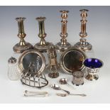 A group of plated items, including a pair of 19th century Sheffield plate candlesticks with