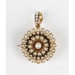 An Edwardian gold and half-pearl pendant brooch, designed as a flowerhead, with a detachable