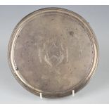 A George III silver circular card salver with raised reeded rim, engraved with a shield shaped