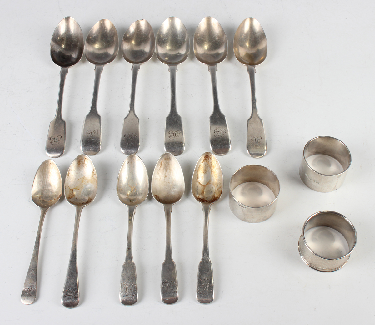 A matched set of six Victorian silver Fiddle pattern dessert spoons, London 1852 and 1862, a set