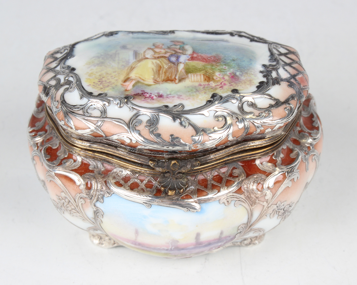 A late 19th/early 20th century German porcelain and silver overlay box, the hinged lid painted