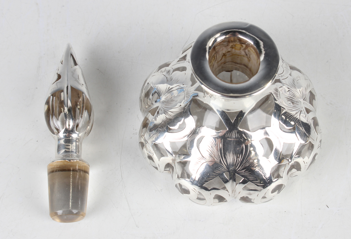 An early 20th century silver overlaid clear glass scent bottle and stopper, the lobed low-bellied - Image 2 of 2