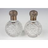 A pair of late Victorian silver mounted cut glass globular scent bottles, each with foliate embossed