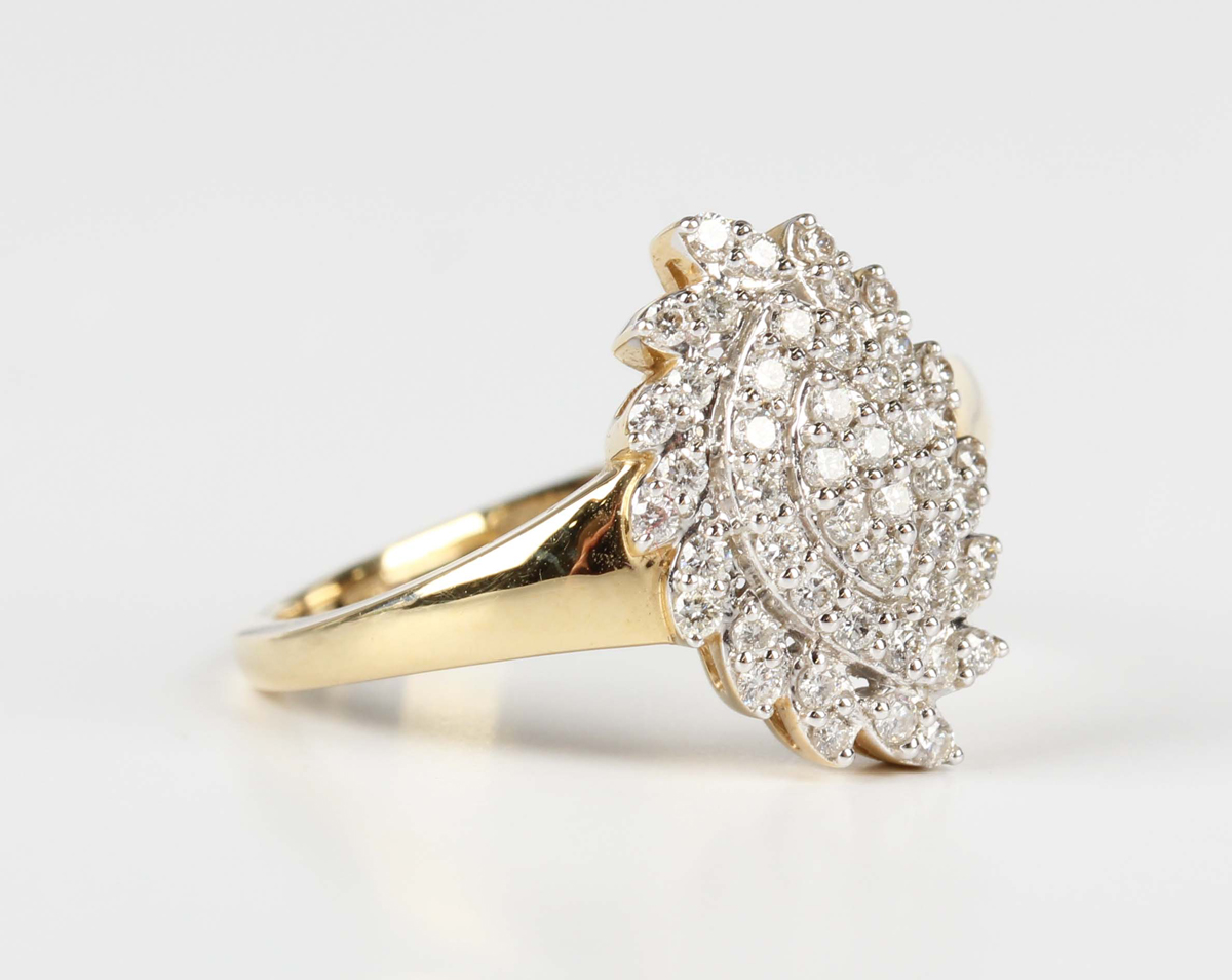 A Tomas Rae 18ct gold and diamond ring in a spiral oval cluster design, mounted with circular cut