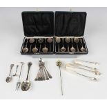 Two sets of six silver teaspoons, both cased, a set of six silver teaspoons, an Edwardian silver