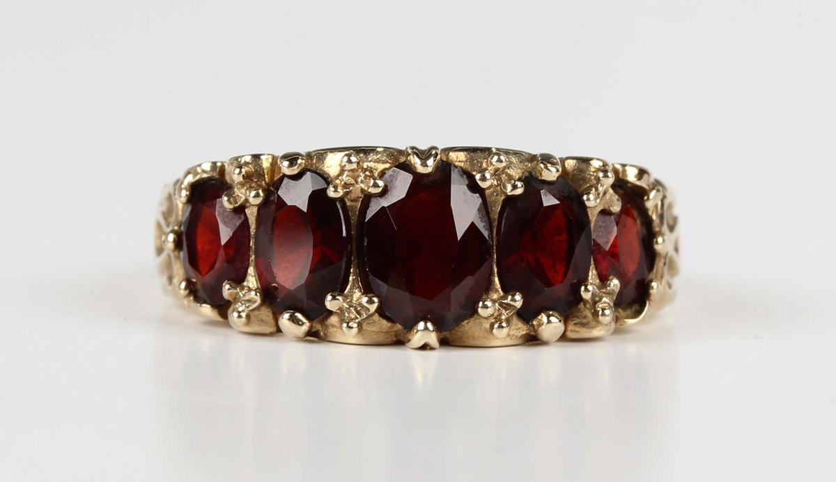 A 9ct gold and garnet five stone ring, claw set with a row of oval cut garnets graduating in size to - Image 5 of 5