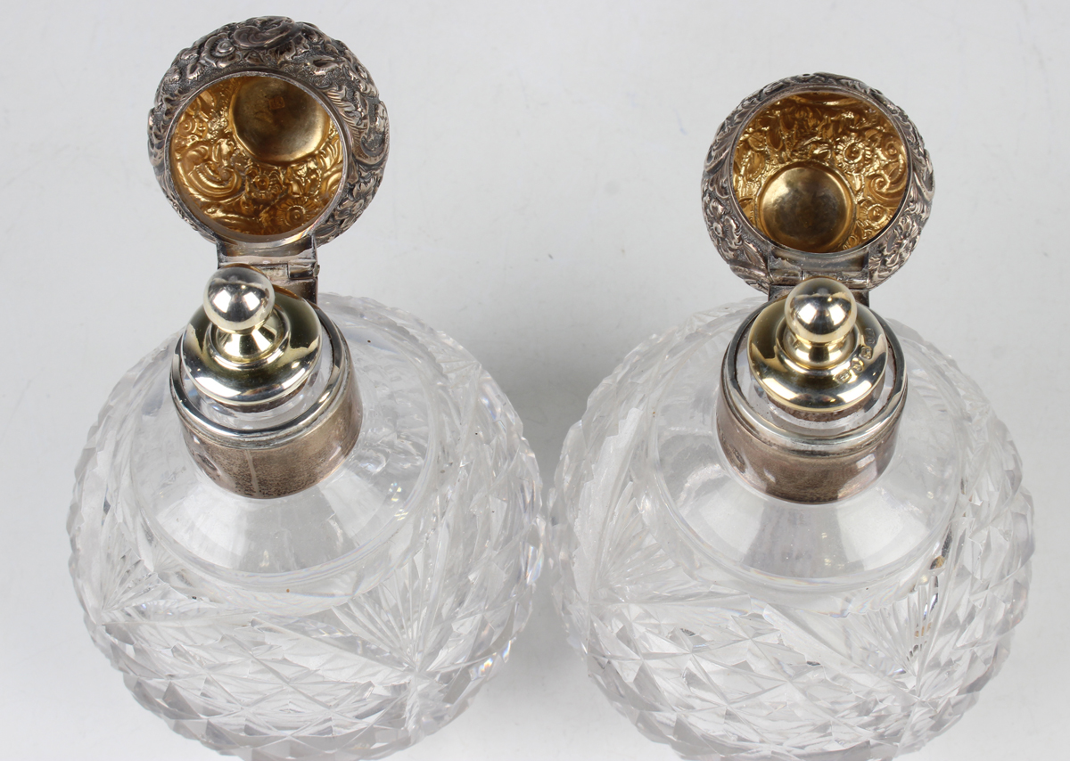 A pair of late Victorian silver mounted cut glass globular scent bottles, each with foliate embossed - Image 3 of 4