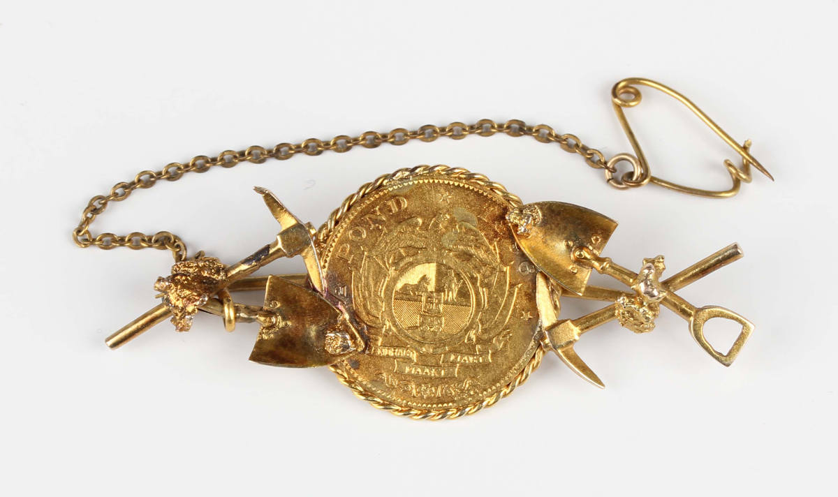 A South African 'gold prospector' brooch, the centre mounted with a half-pond 1896, the sides with