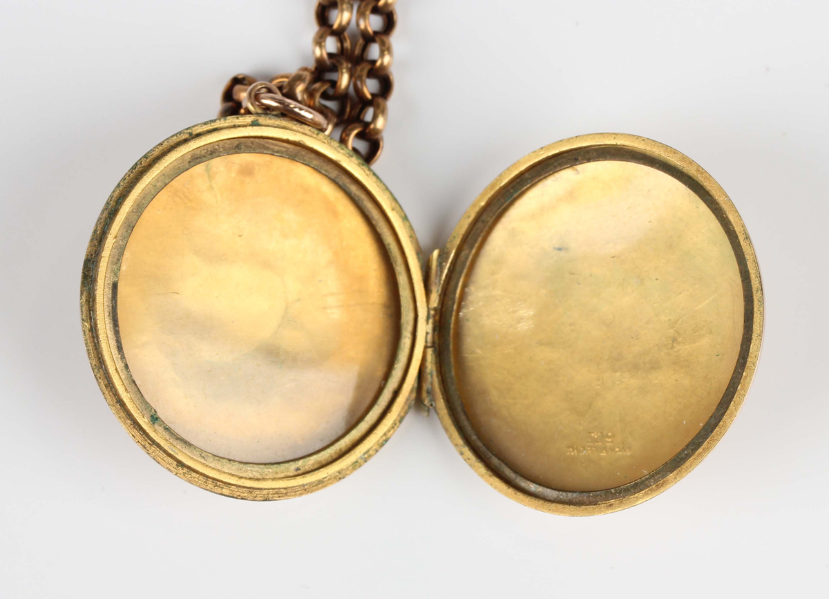 A gold back and front circular pendant locket with foliate engraved decoration, the front monogram - Image 2 of 4