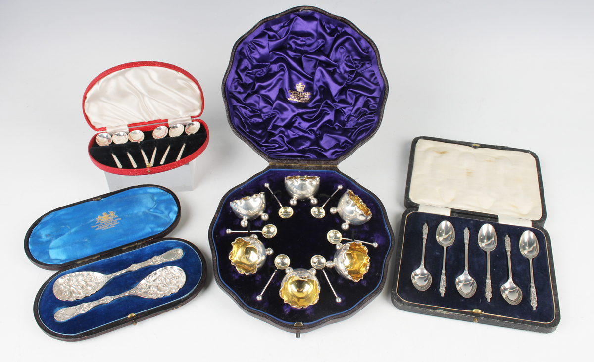 A set of six Victorian silver salts of circular form with pinched rims and gilt interiors, on ball