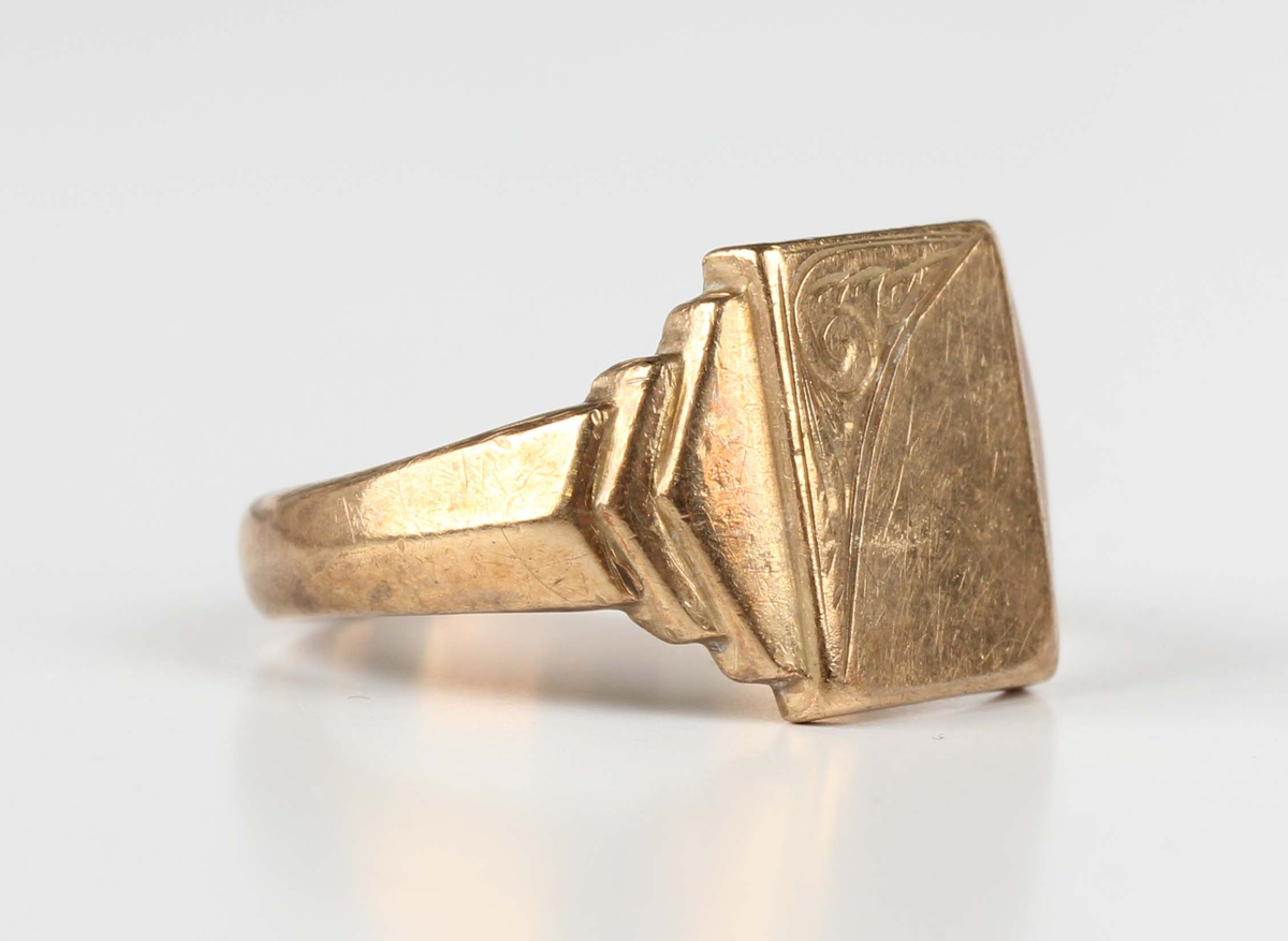 A 9ct gold rectangular signet style ring with stepped shoulders, Birmingham 1971, weight 5.2g,