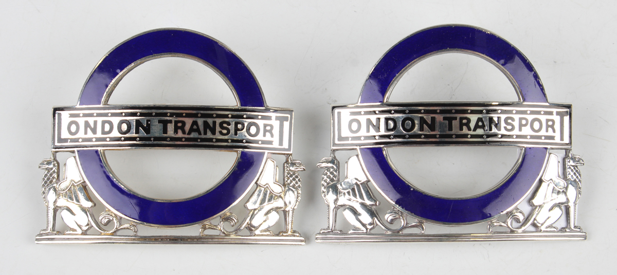 Two George V silver and blue enamelled 'London Transport' cap badges, each back detailed with a