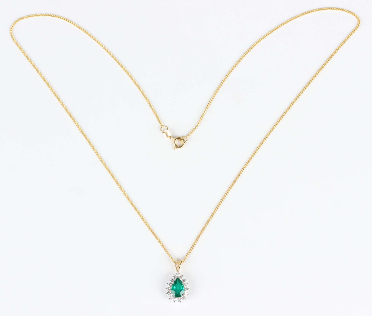 An 18ct two colour gold, emerald and diamond cluster pendant, claw set with a pear shaped emerald - Image 4 of 4