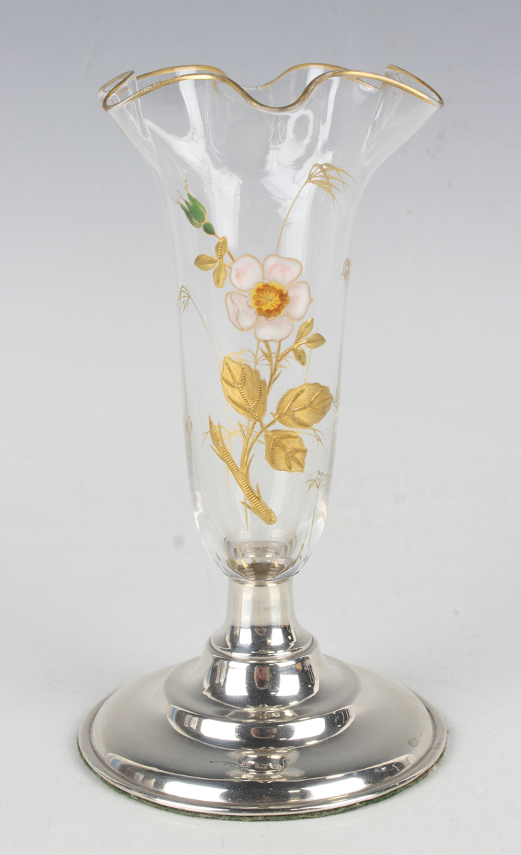 A silver and enamelled clear glass posy vase, the slender glass body enamelled and gilt with a