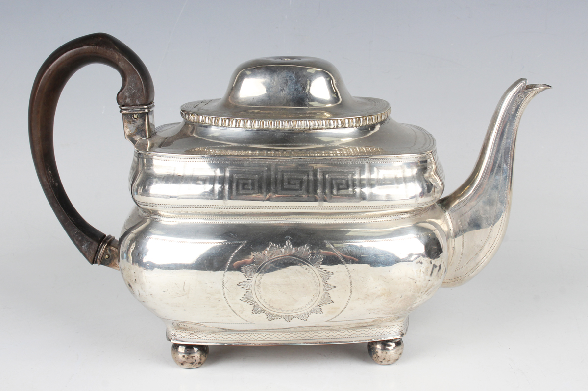 A George III Irish silver cushion shaped teapot, engraved with Greek key banded decoration, Dublin