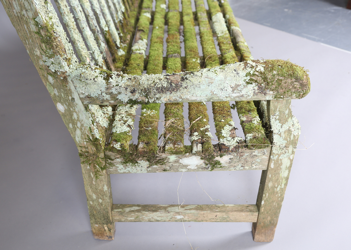 A 20th century teak garden bench, covered in green lichen, height 81cm, width 182cm, depth 70cm. - Image 2 of 11