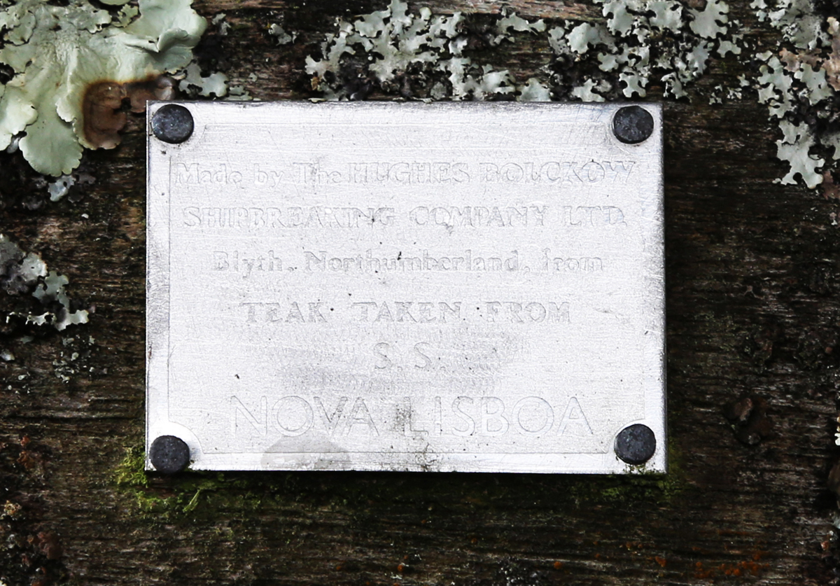 A 20th century teak garden bench, covered in green lichen, height 81cm, width 182cm, depth 70cm. - Image 4 of 11