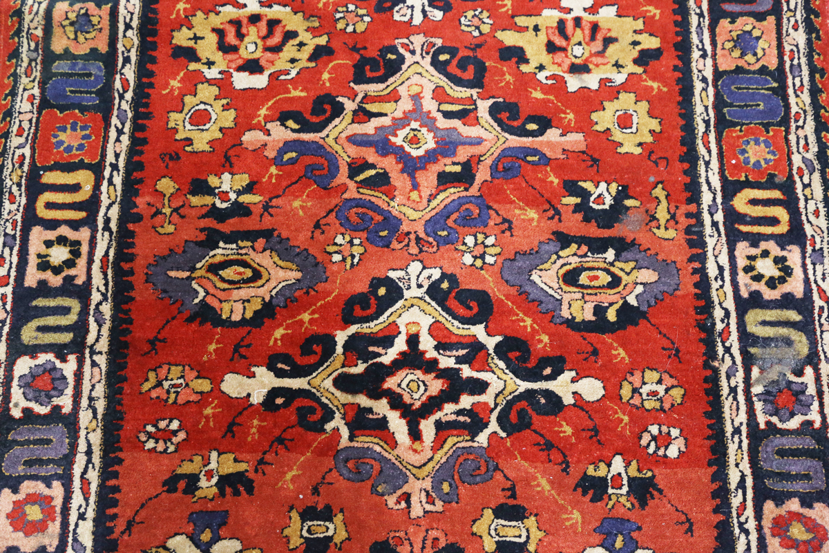 A Persian style rug, 20th century, the deep terracotta field with a column of palmettes, within a - Image 11 of 12