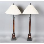 A pair of Georgian style mahogany table lamps by Theodore Alexander, the tapering fluted stems