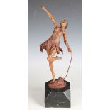 A painted cast spelter figure of an Amazonian female, holding a long strand of vine, mounted on a