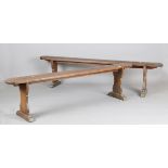 A pair of early 20th century French stained pine benches, height 48cm, length 196cm, depth 20cm.