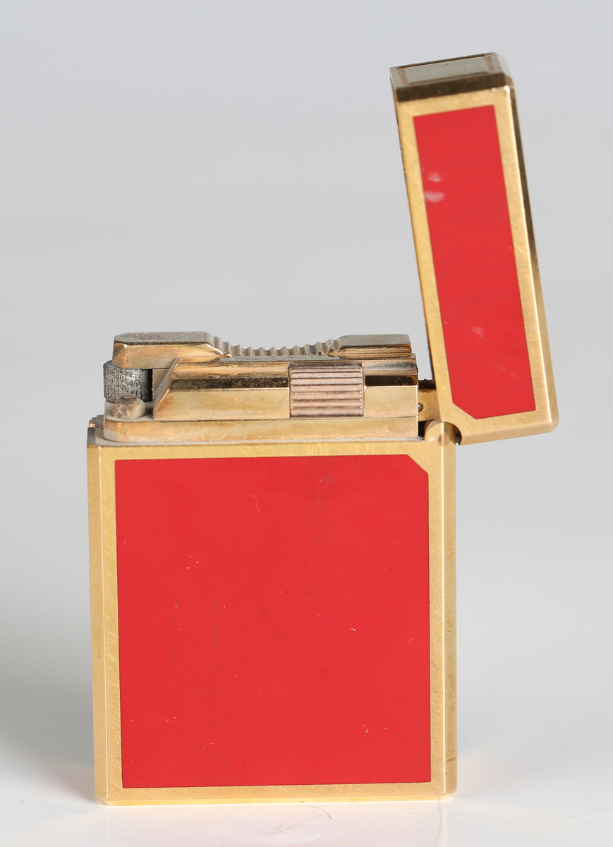 An S.T. Dupont Paris gilt metal and red enamel pocket lighter, detailed 'B5AG53', length 4.6cm, - Image 5 of 8