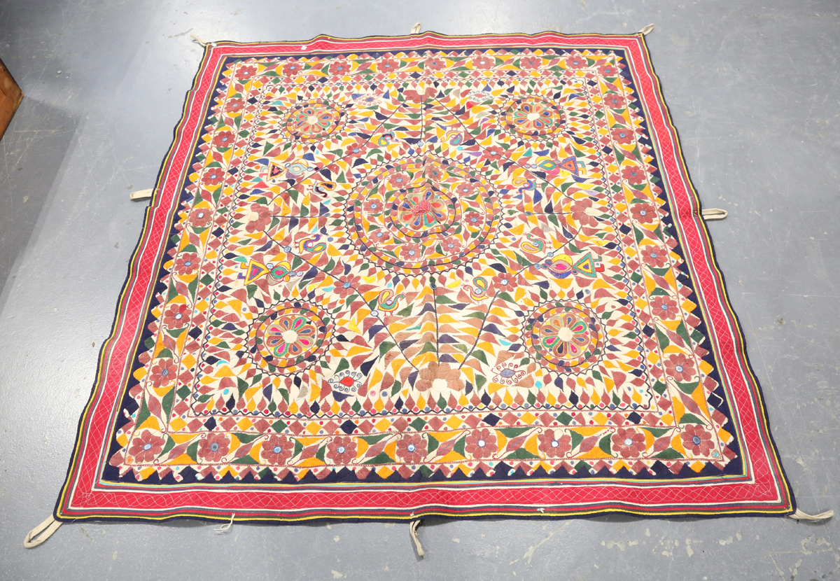 An Indian kutch needlework hanging, embroidered in polychrome threads and embellished with