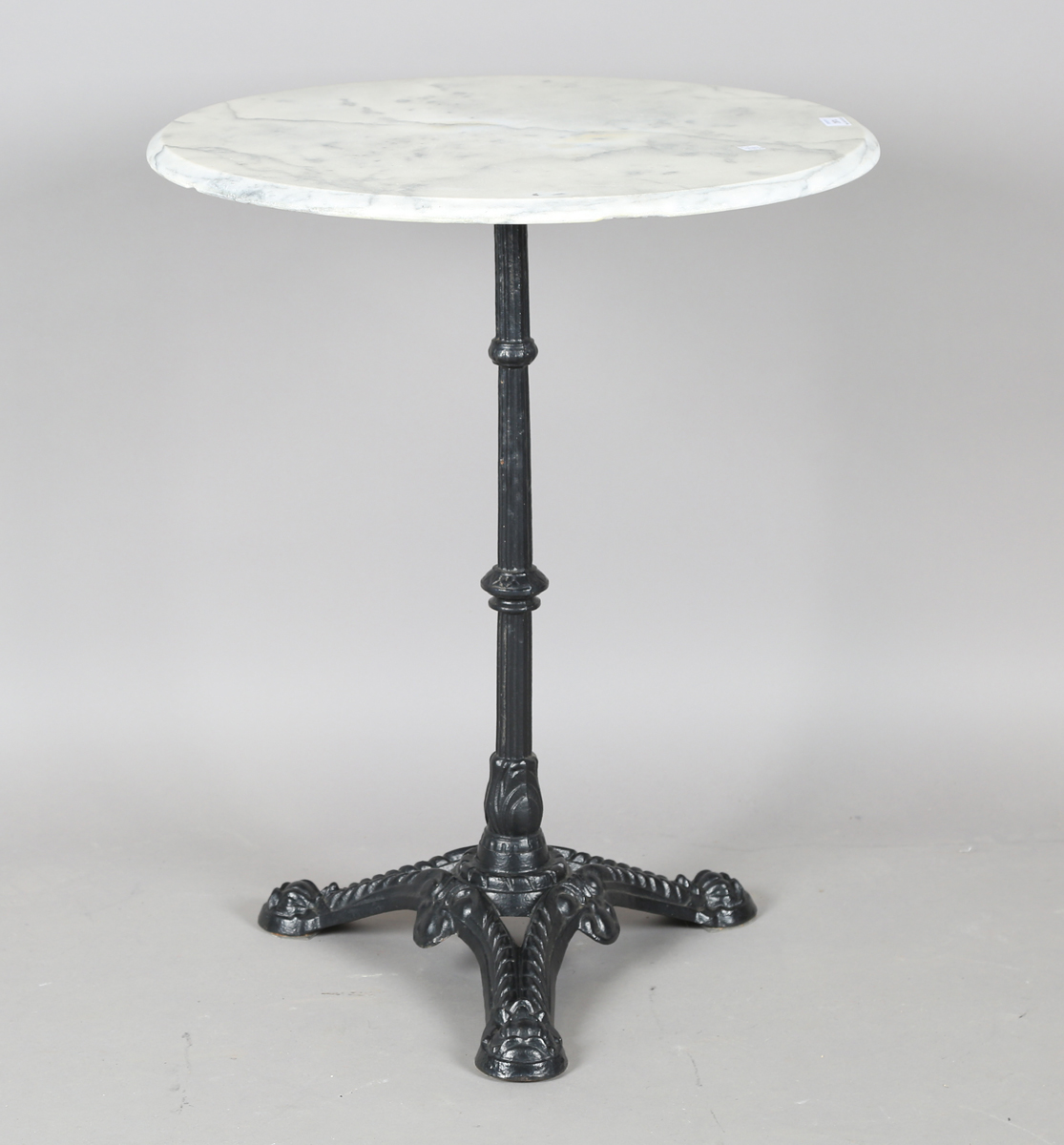 A 20th century black painted cast iron and marble-topped table, height 74cm, diameter 60cm.Buyer’s