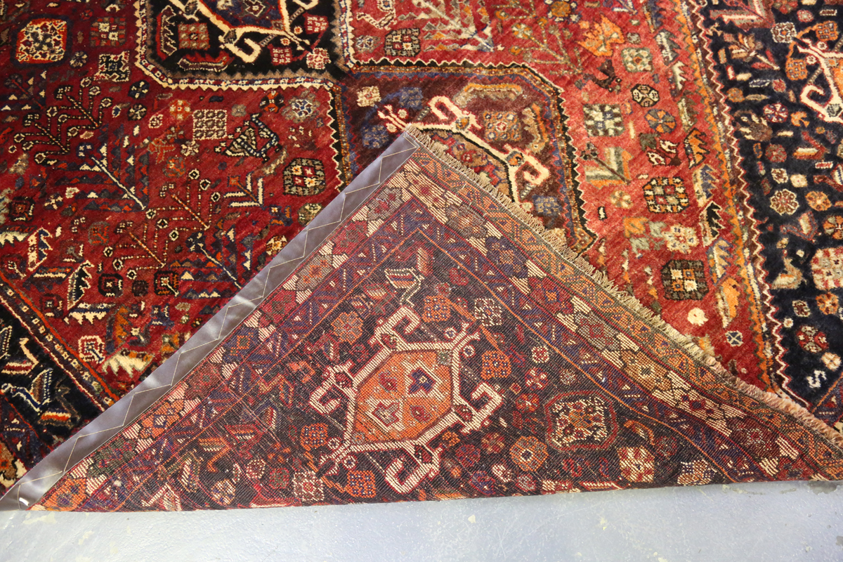 A Ghashghai rug, South-west Persia, late 20th century, the red field with three linked medallions, - Image 3 of 8