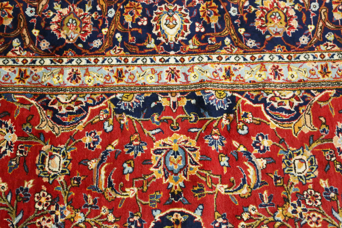 A Kashan carpet, Central Persia, modern, the red field with a shaped medallion, within a blue - Image 5 of 9