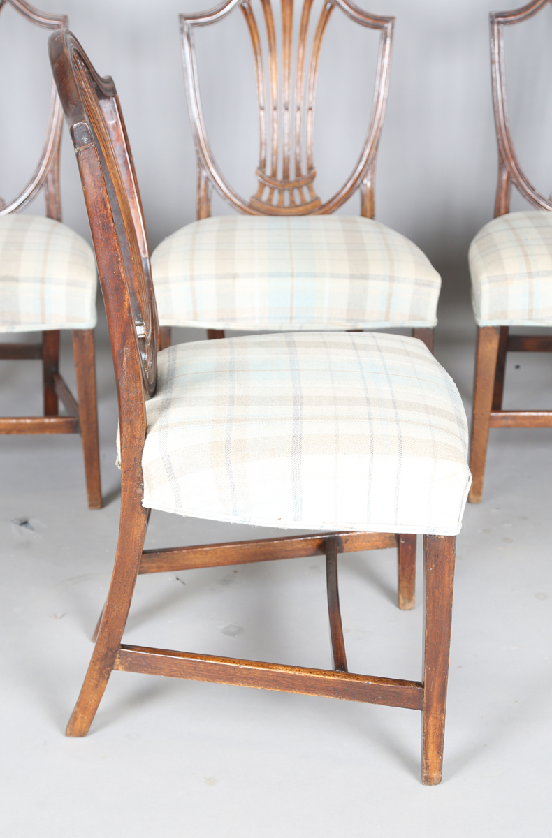A set of four George III mahogany dining chairs with pierced splat backs and overstuffed seats, - Image 7 of 12