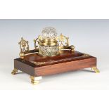 An early 20th century mahogany and brass mounted desk standish with galleried back and large central
