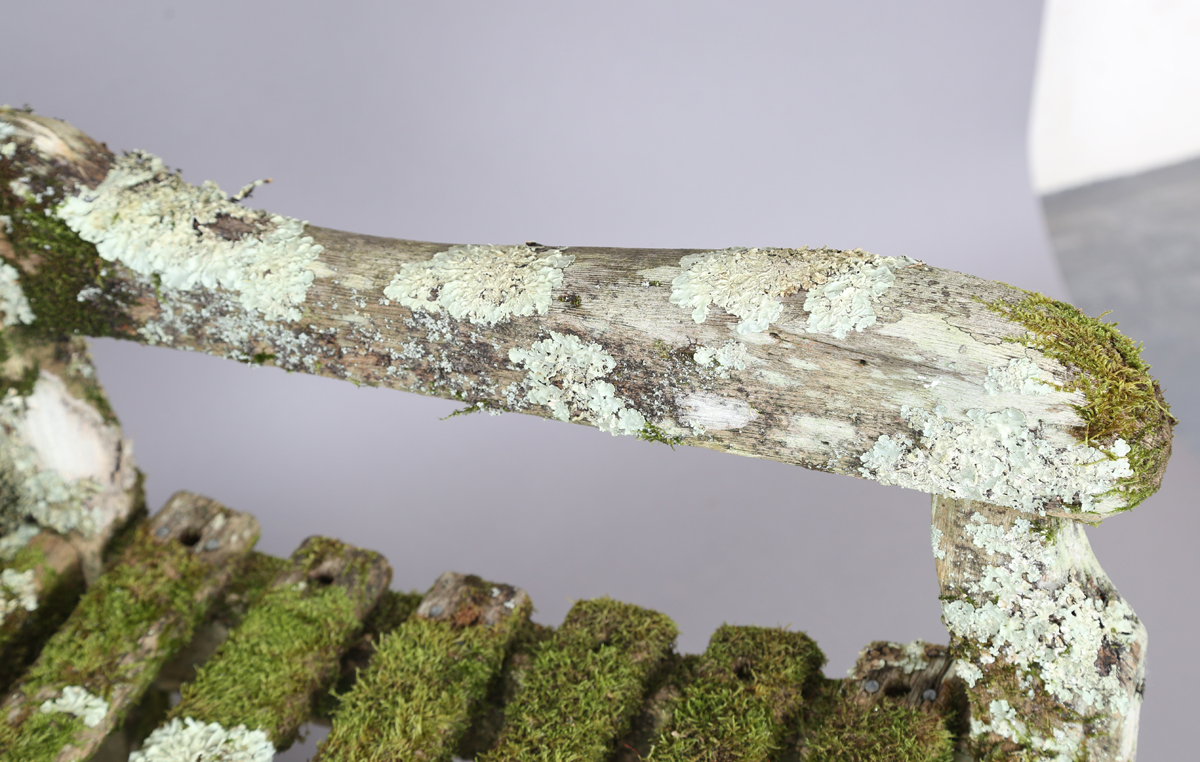 A 20th century teak garden bench, covered in green lichen, height 81cm, width 182cm, depth 70cm. - Image 7 of 11