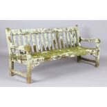 A 20th century teak garden bench, covered in green lichen, height 81cm, width 182cm, depth 70cm.