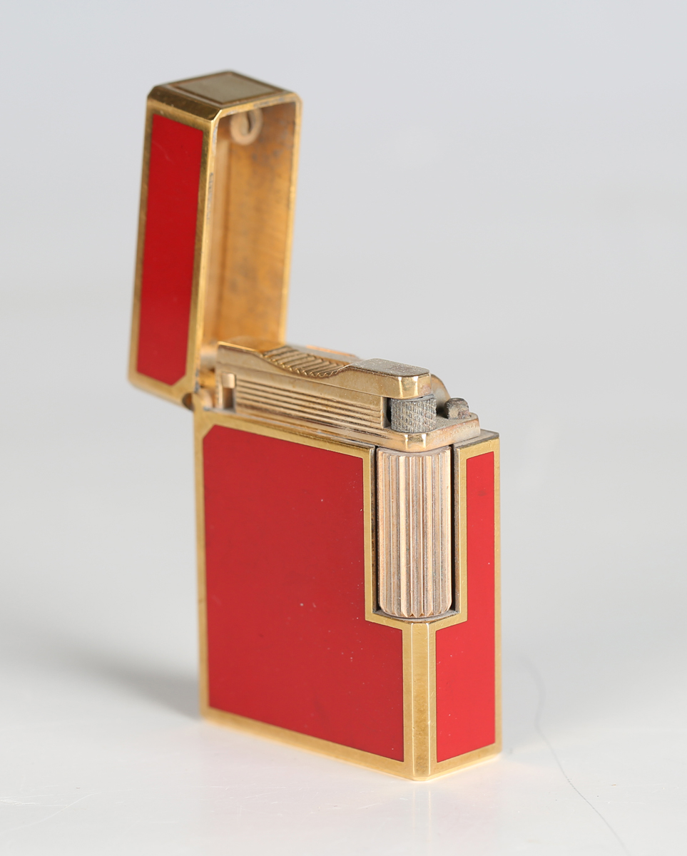 An S.T. Dupont Paris gilt metal and red enamel pocket lighter, detailed 'B5AG53', length 4.6cm, - Image 8 of 8