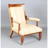 A William IV mahogany showframe library armchair, upholstered in golden yellow striped fabric,