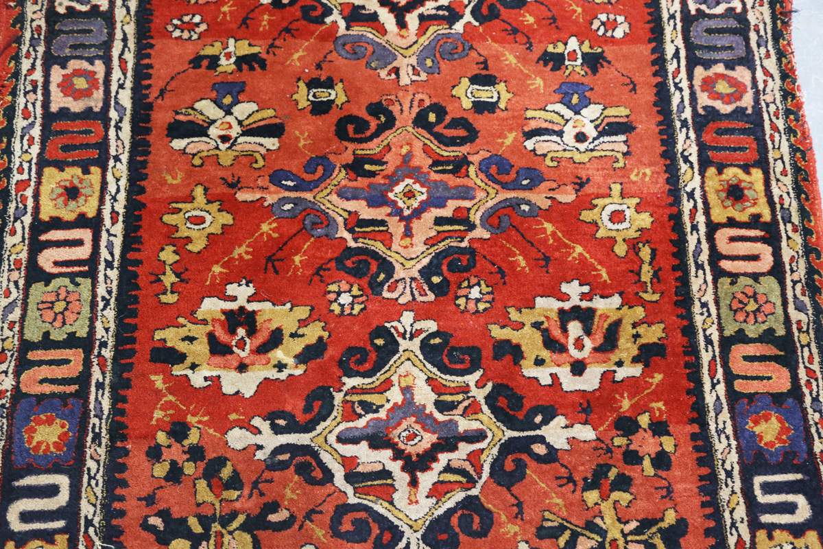 A Persian style rug, 20th century, the deep terracotta field with a column of palmettes, within a - Image 10 of 12