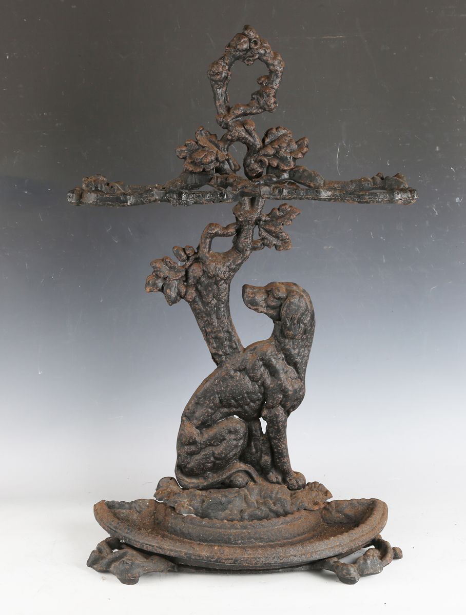 A Victorian style cast iron stick stand with seated dog support, height 69cm.Buyer’s Premium 29.