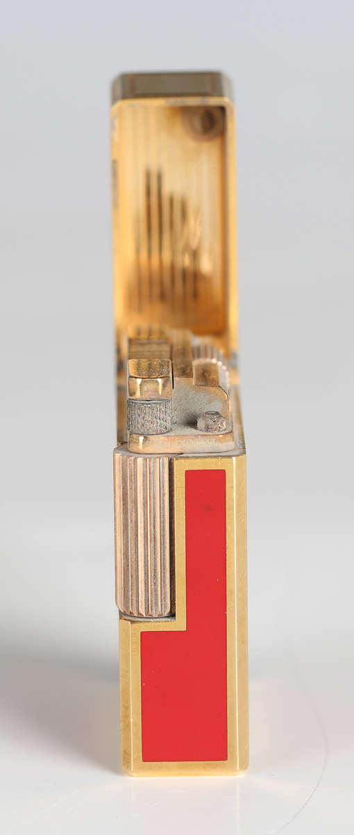 An S.T. Dupont Paris gilt metal and red enamel pocket lighter, detailed 'B5AG53', length 4.6cm, - Image 6 of 8