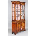 A late 20th century Bevan Funnell mahogany display cabinet, the moulded pediment above astragal
