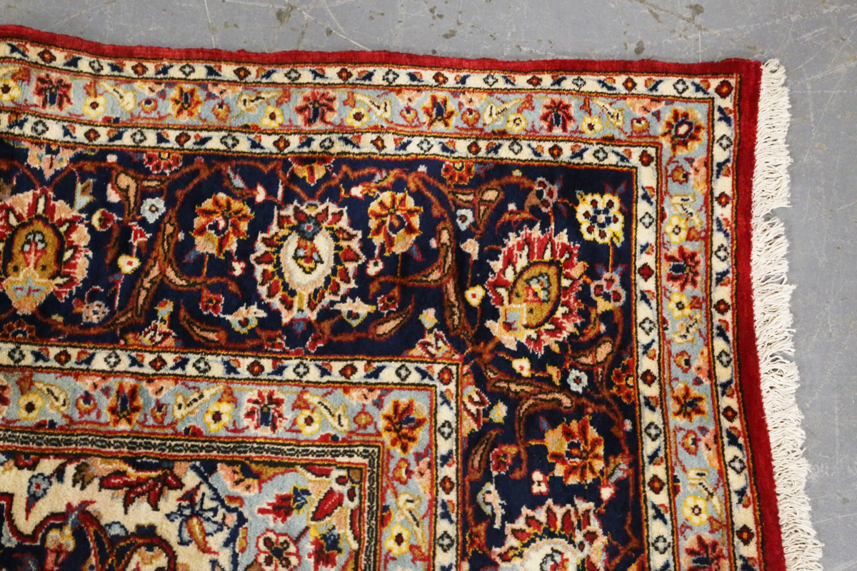 A Kashan carpet, Central Persia, modern, the red field with a shaped medallion, within a blue - Image 6 of 9